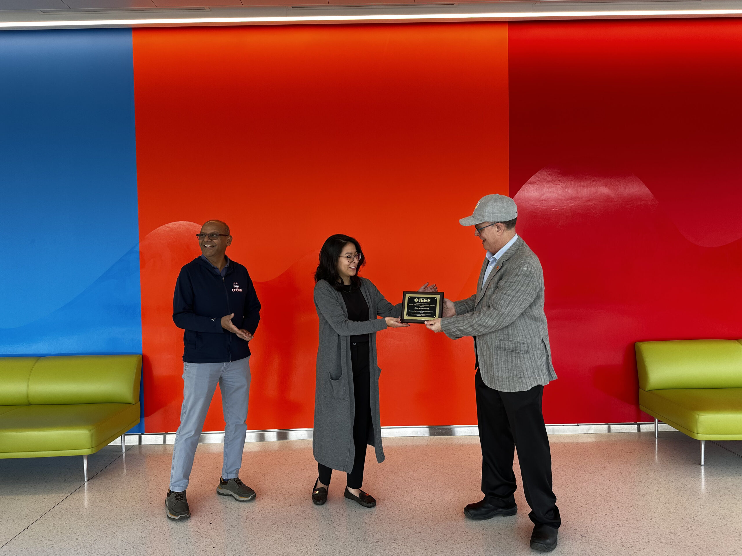 Ravi Gorthala, Clara Ramirez receiving her award, and Peter Kootsookos